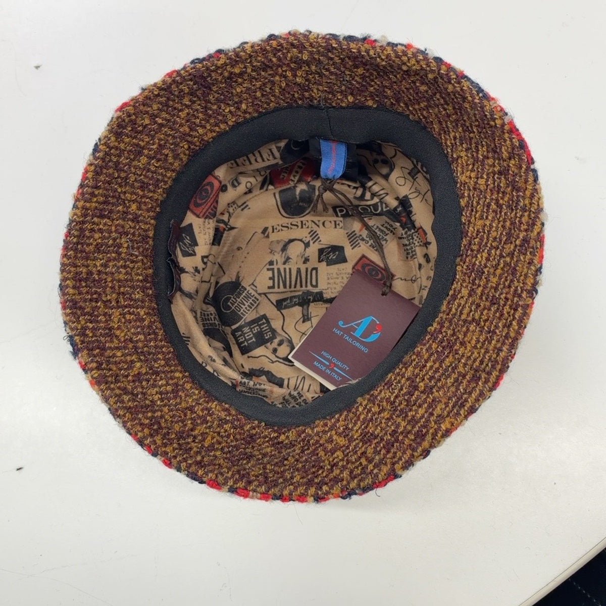 Interior of Alfonso D'Este Nanni patchwork bucket hat 35969 showing printed lining and brown textured underbrim