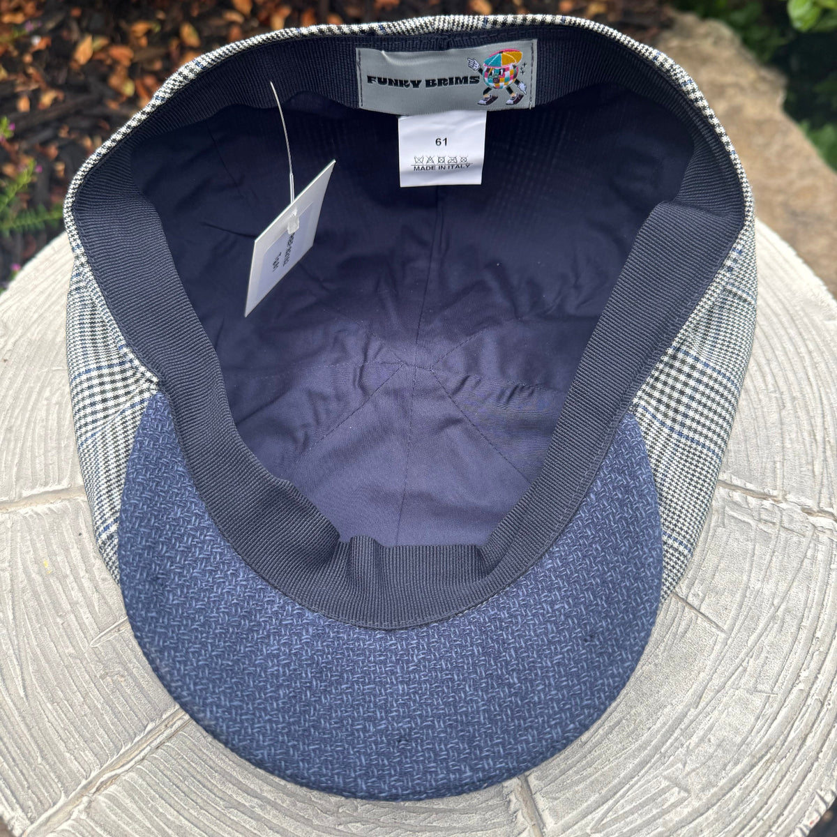 A close-up of a cap's interior showing a blue herringbone patterned visor, a dark gray ribbed band, a gray and white gingham patterned side panel, and a visible 'FUNKY BRIMS' brand label.
