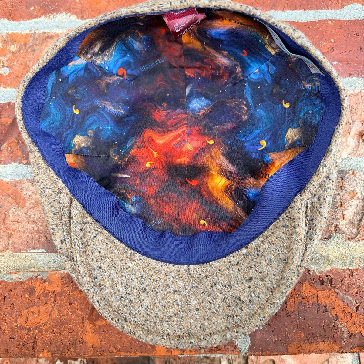 Interior view of the Masterpiece da Vinci Flat Cap by FunkyBrims, showing the colorful illustrated lining.