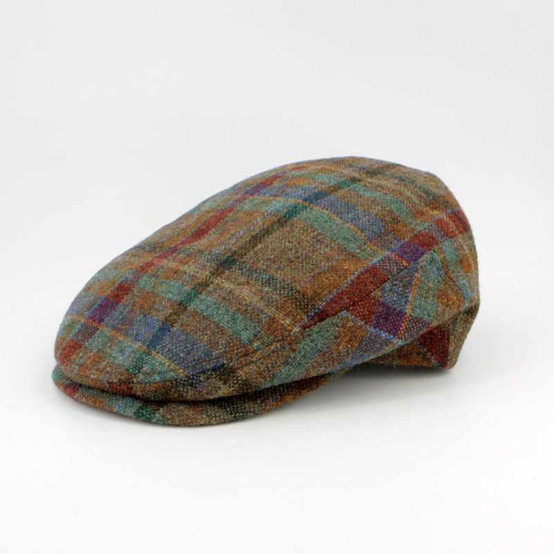 A classic flat cap in a brown, blue, and red plaid tweed pattern, photographed on a seamless white background.