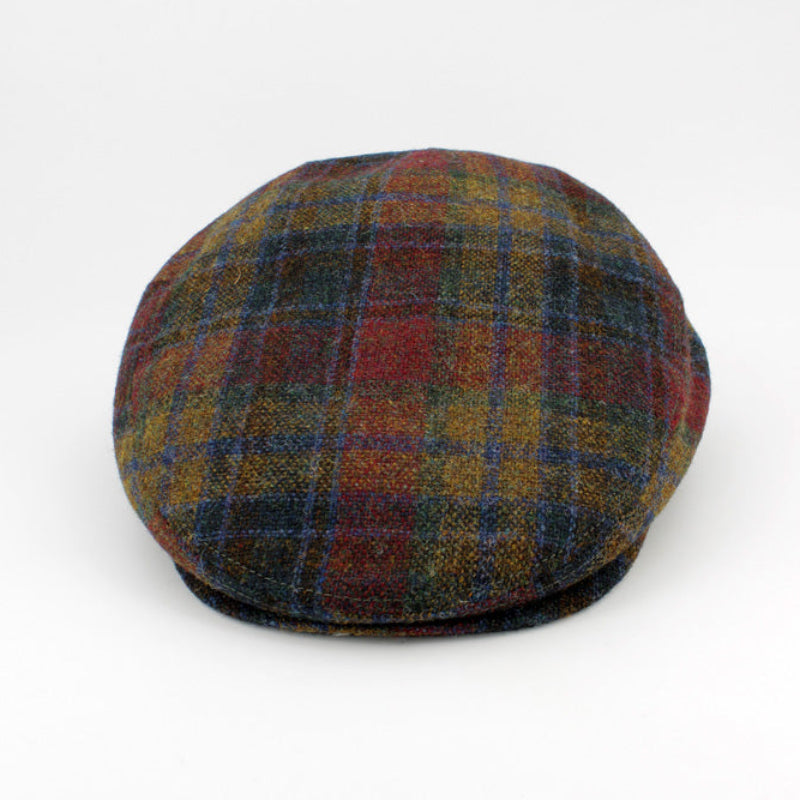 A classic flat cap in a multicolor plaid pattern featuring red, blue, yellow, and green tones, photographed on a clean white background.