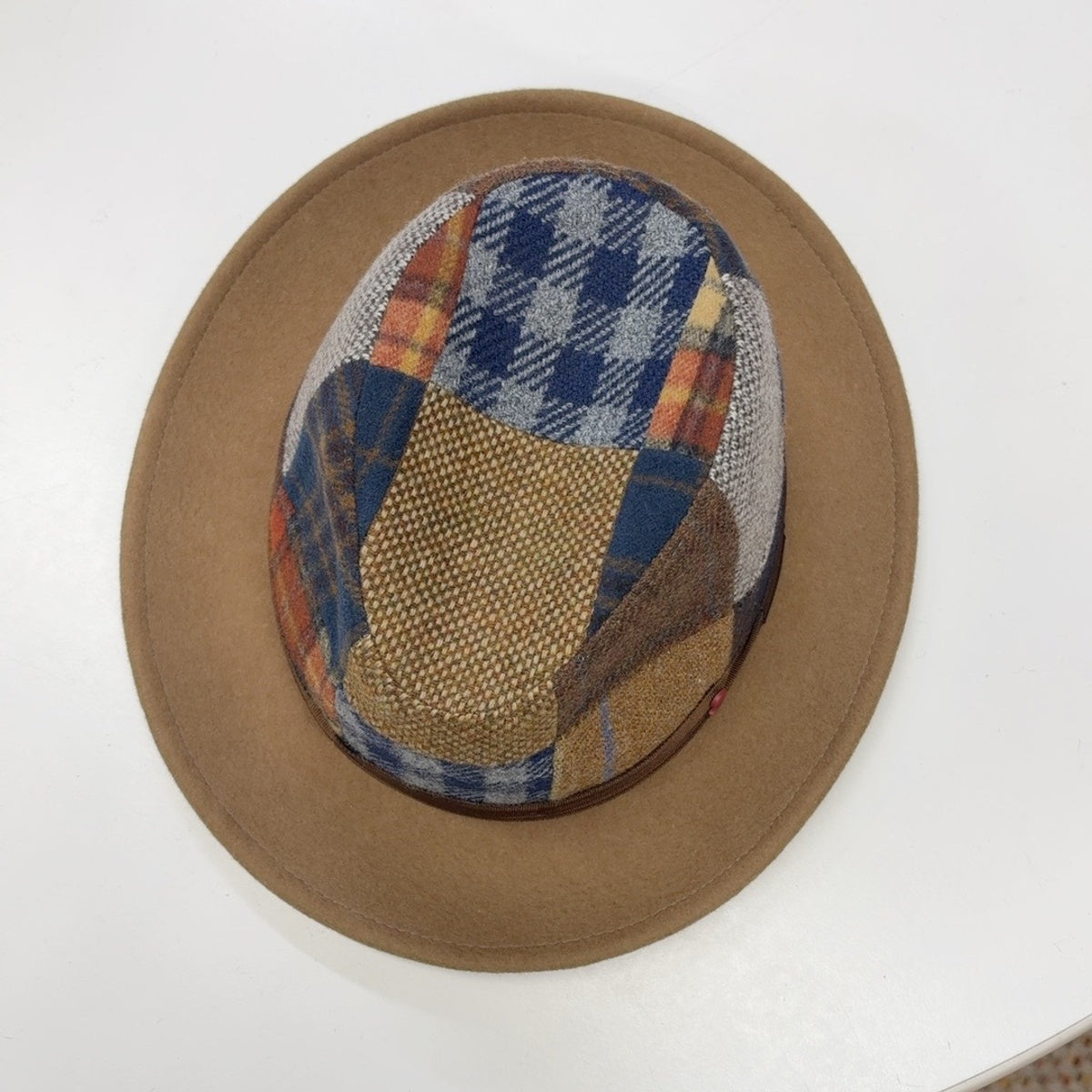 Top view of Alfonso D'Este patchwork fedora 24719 showing navy, gray, mustard and rust fabric panels