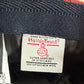 Harris Tweed label on a woven fabric background at Funky Brims