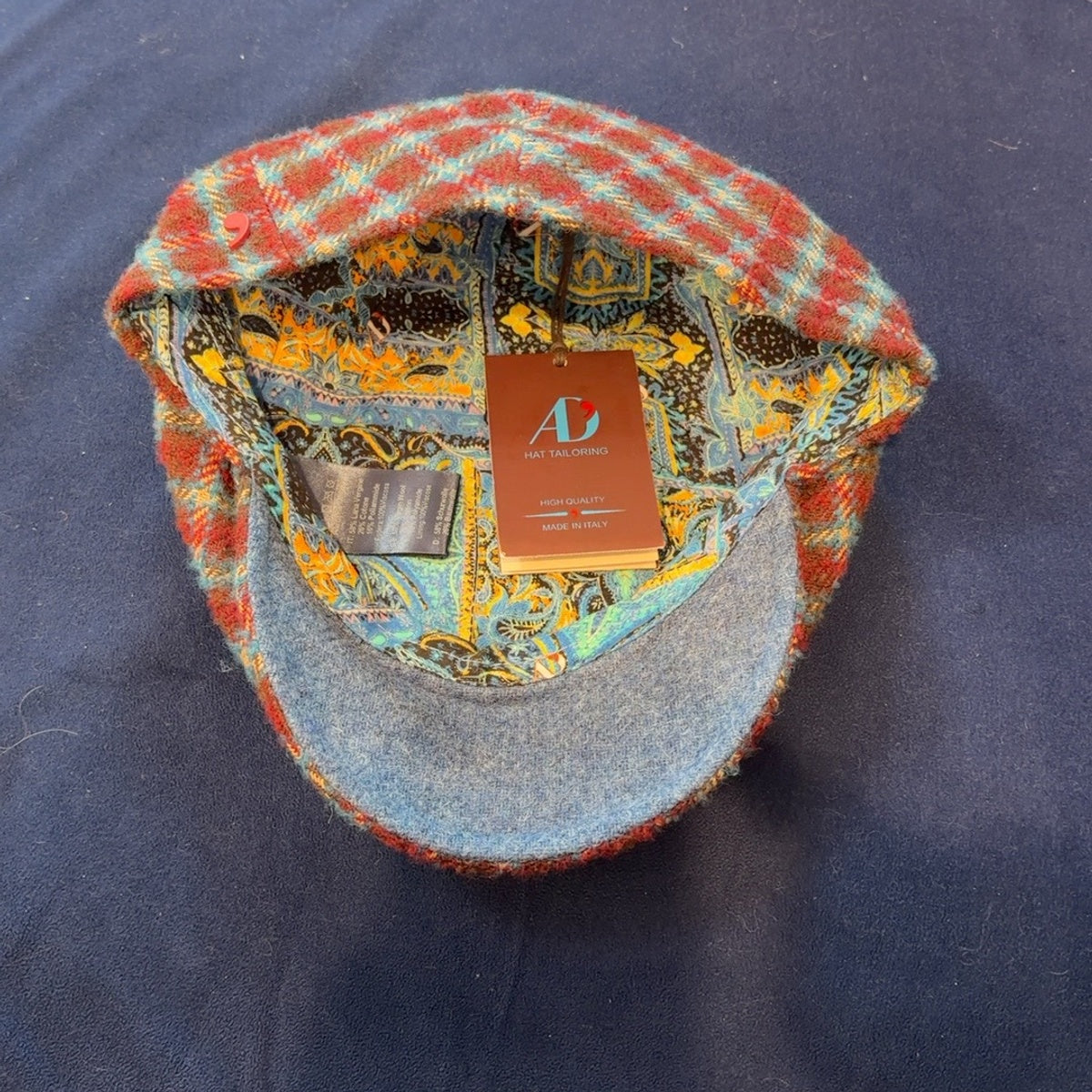 Interior of Rudy flat cap with colorful paisley lining and blue-gray underbrim