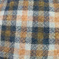 Close-up of blue, tan and gray plaid virgin wool fabric