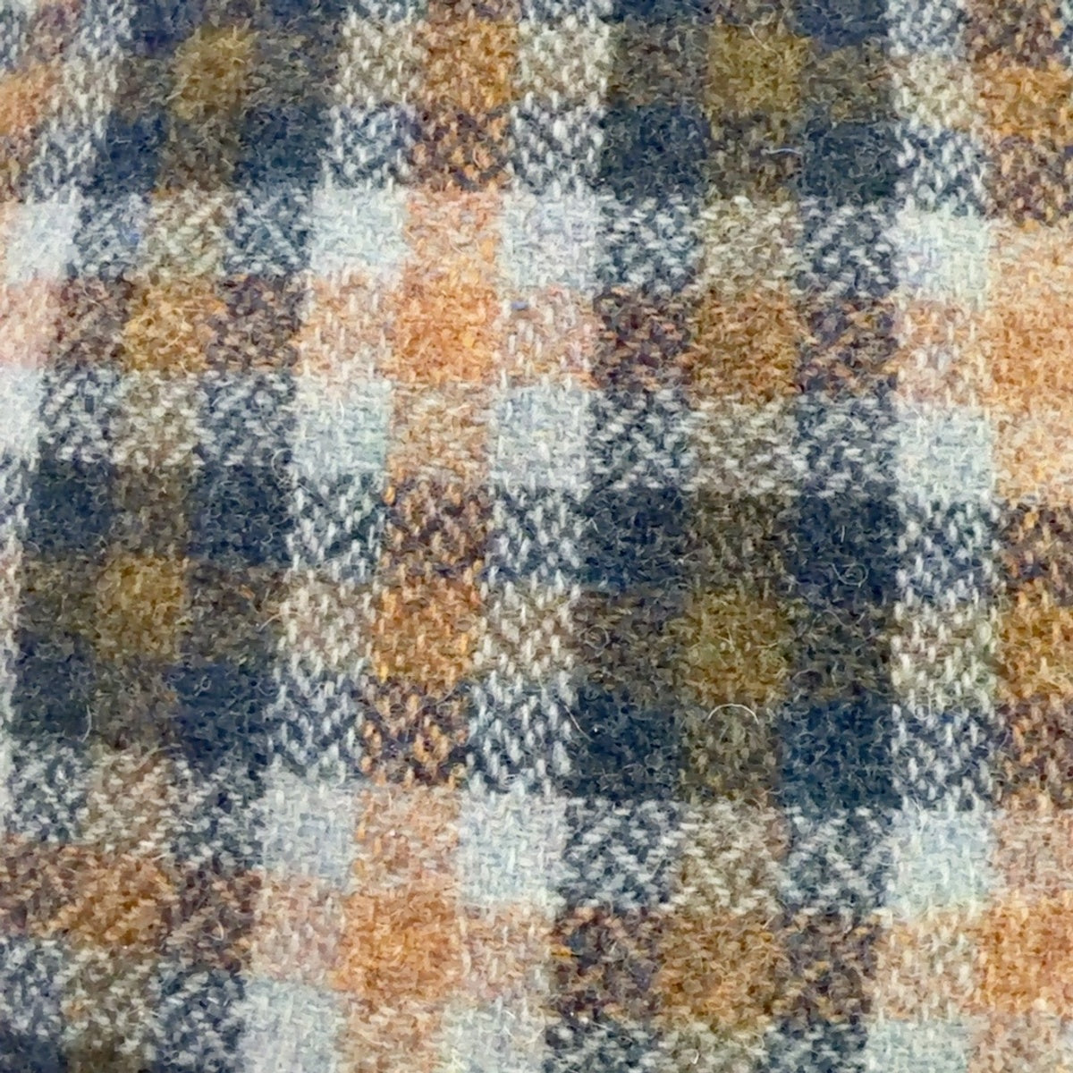 Close-up of blue, tan and gray plaid virgin wool fabric