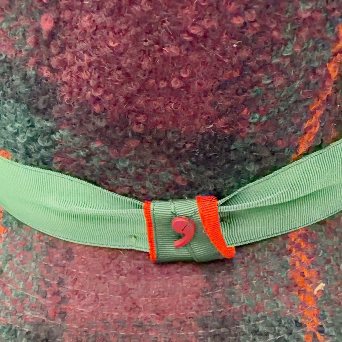 Close-up of Potenza fedora 35713 showing textured plaid and green grosgrain ribbon with orange trim
