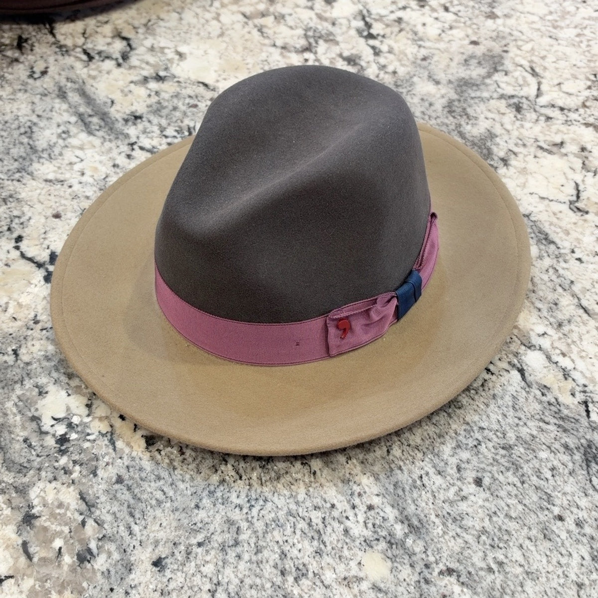 Indiana fedora with charcoal gray crown, tan brim and mauve band with navy accent