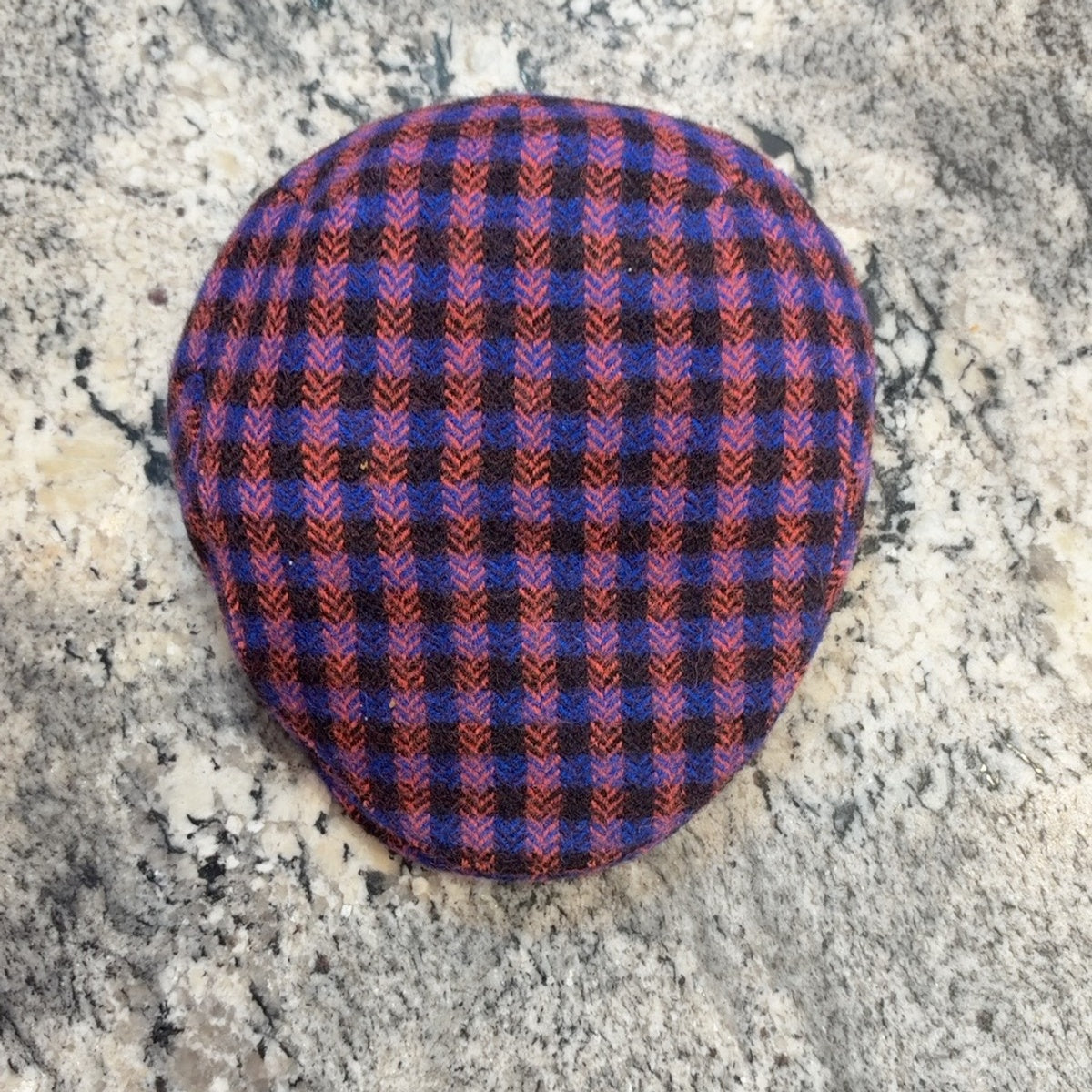 Top view of blue and coral check flat cap