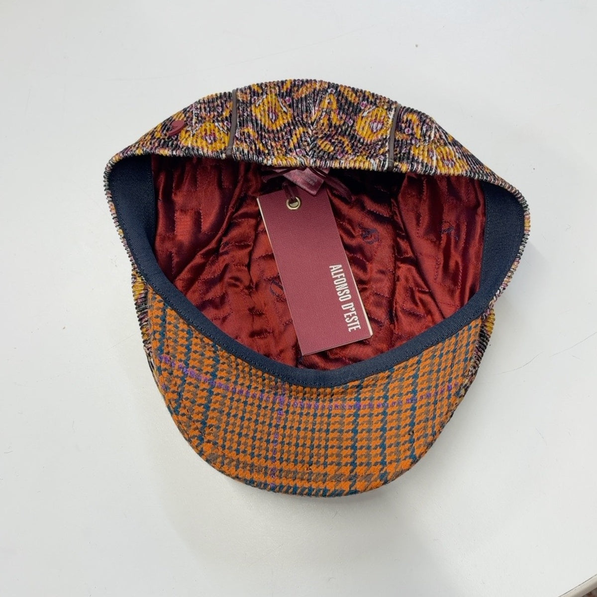 Alfonso D'Este John 42028 cap showing burgundy lining and orange checked underbrim