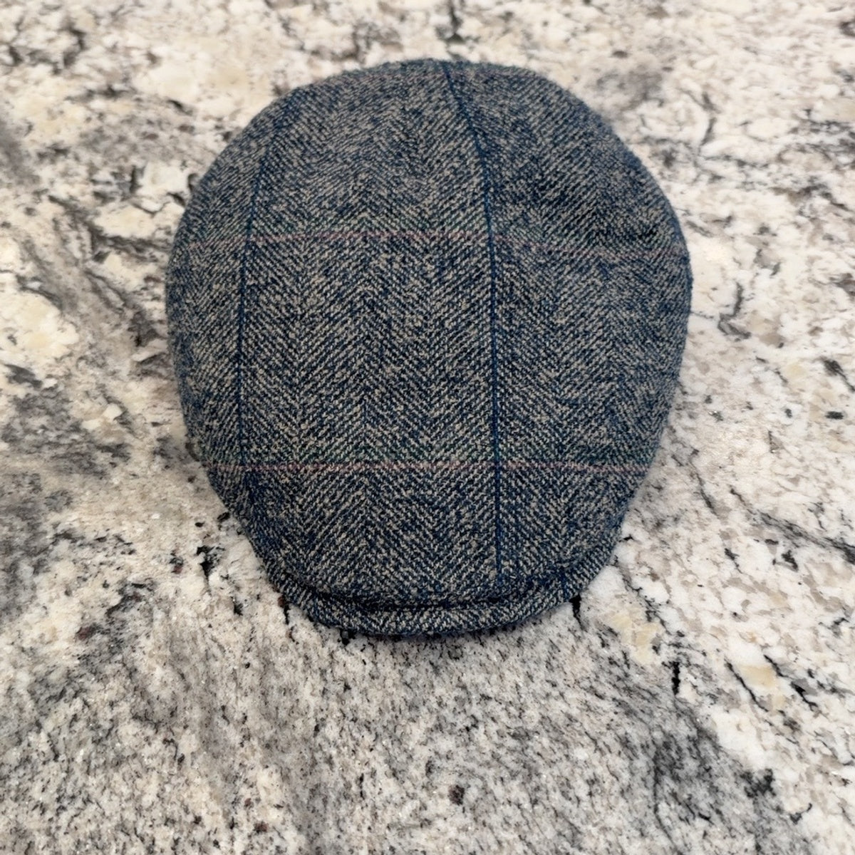 Top view of Ionio herringbone flat cap with subtle windowpane check
