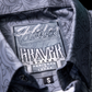 Close-up of the inside collar of a patterned button-up shirt showing the Hales Maverick label, with a small black size tag marked S.