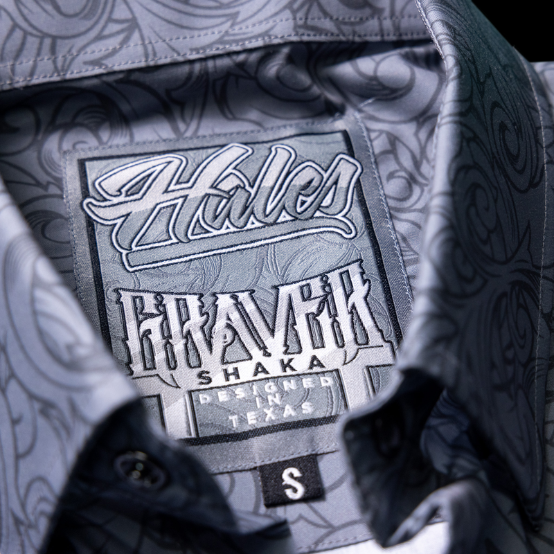 Close-up of the inside collar of a patterned button-up shirt showing the Hales Maverick label, with a small black size tag marked S.