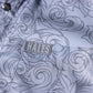 Close-up of a light blue-gray patterned shirt pocket with a gray embroidered Hales brand patch.