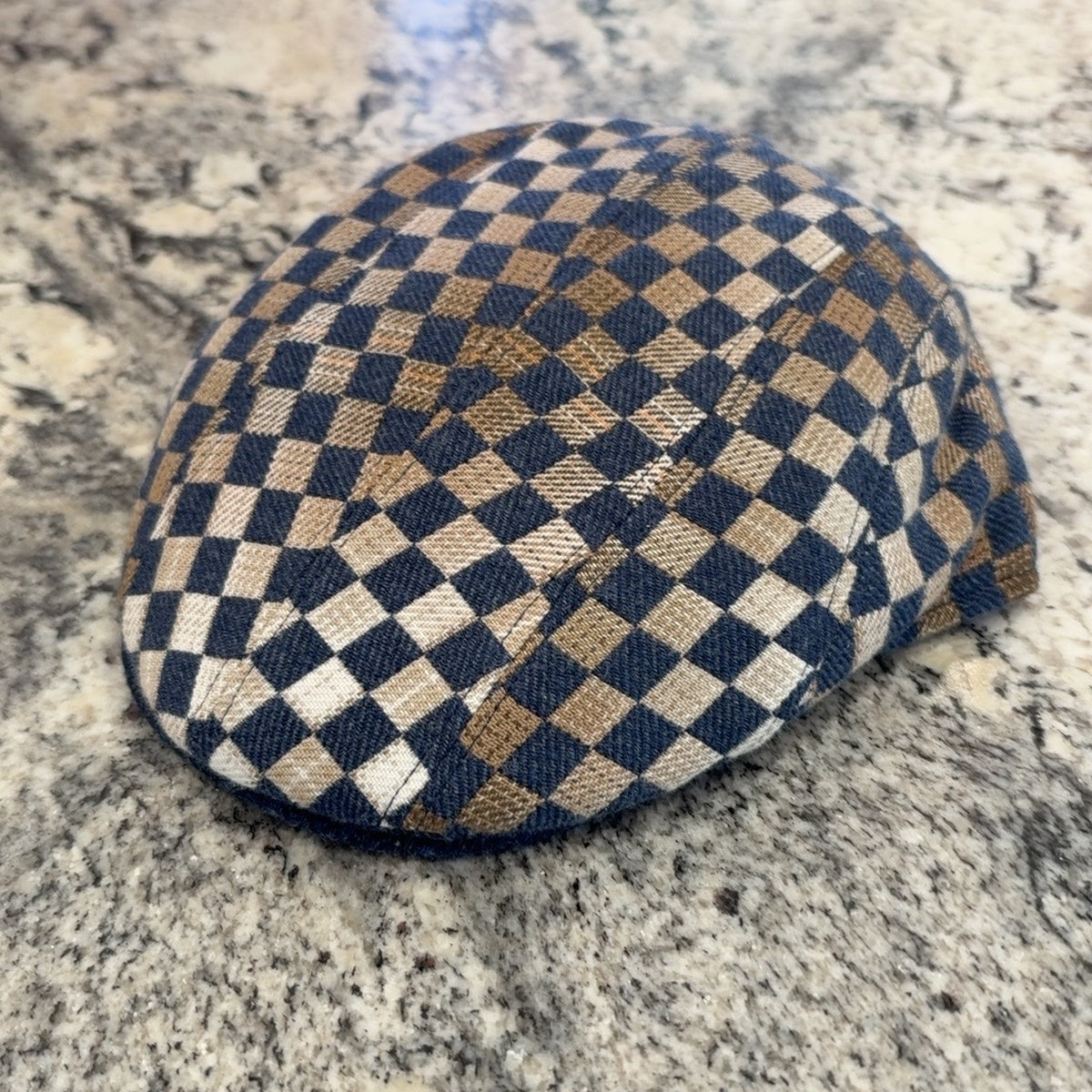 Alfonso d’Este John blue, tan and cream checkerboard flat cap 47545, front angle