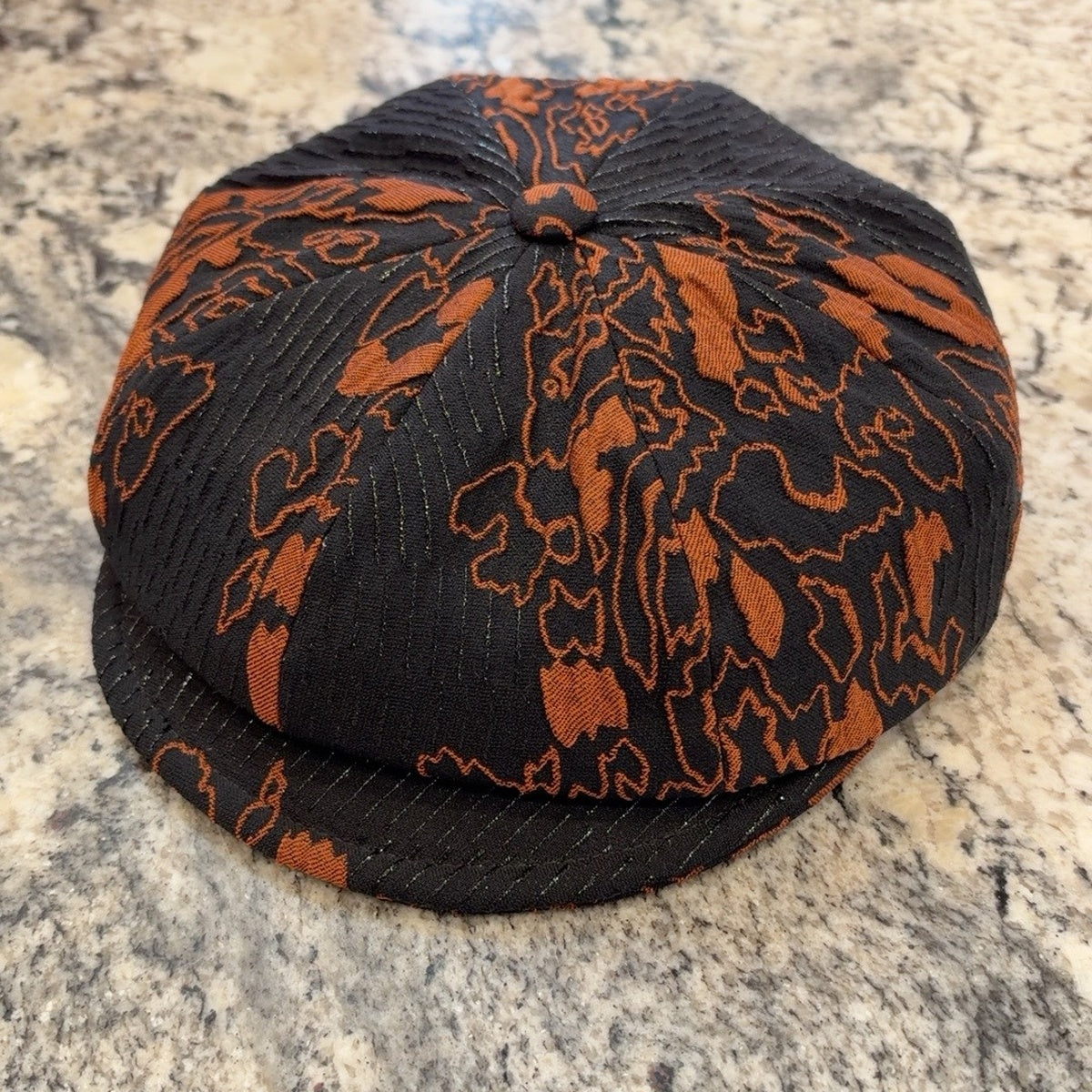 Alfonso d’Este Krizia black and burnt orange floral newsboy cap 52066, front view