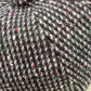Close-up of black and white virgin wool weave with colorful flecks on cap 52263