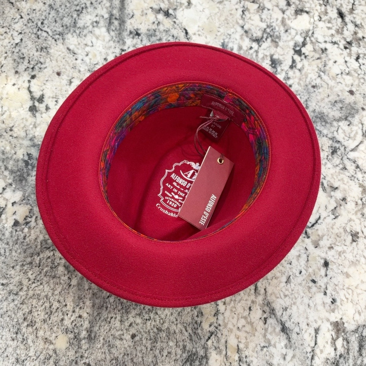 Interior of red Orlando fedora showing colorful sweatband and crushable marking
