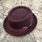 Burgundy Alfonso D’Este pork pie hat with tonal ribbon and mauve bow accent