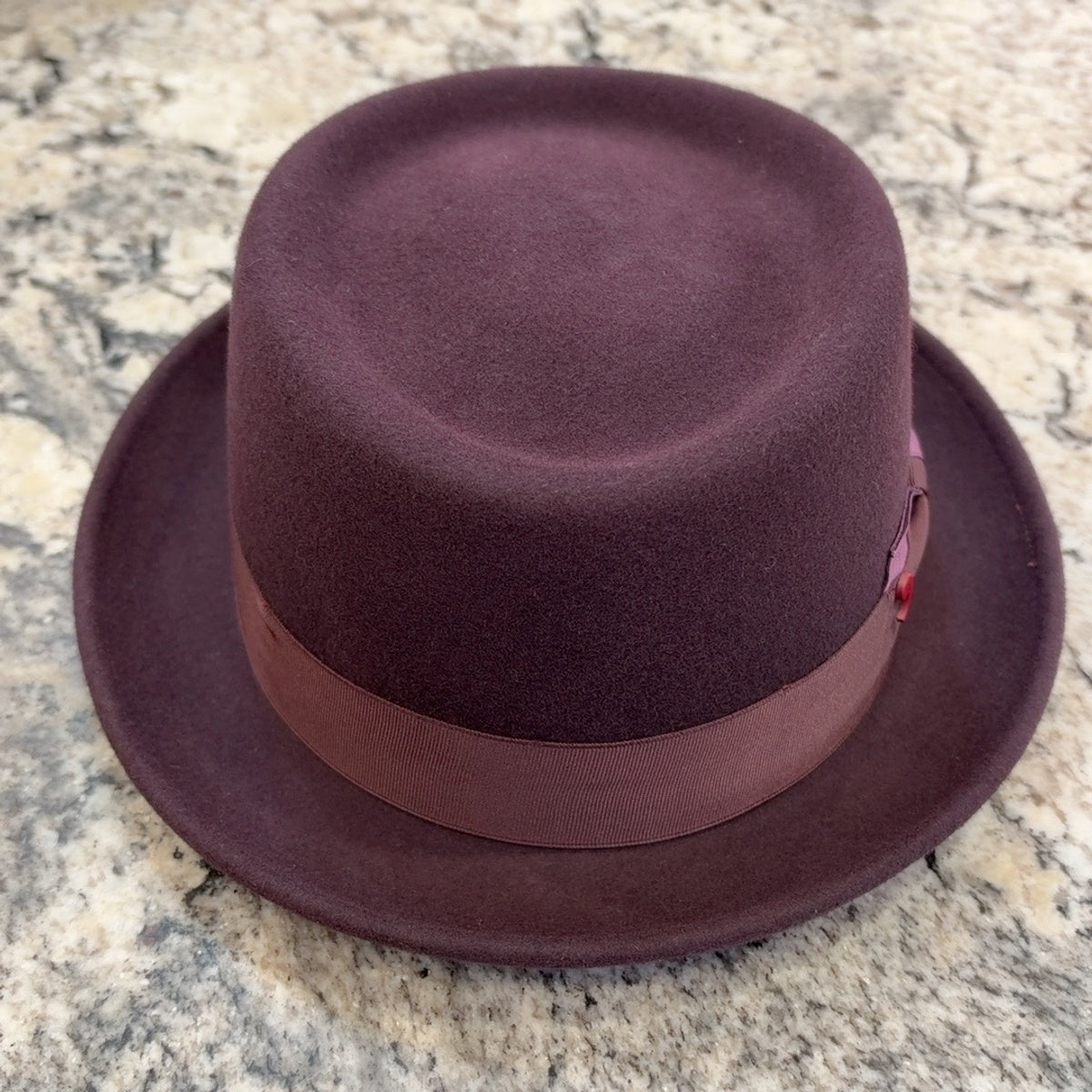 Front view of burgundy pork pie hat