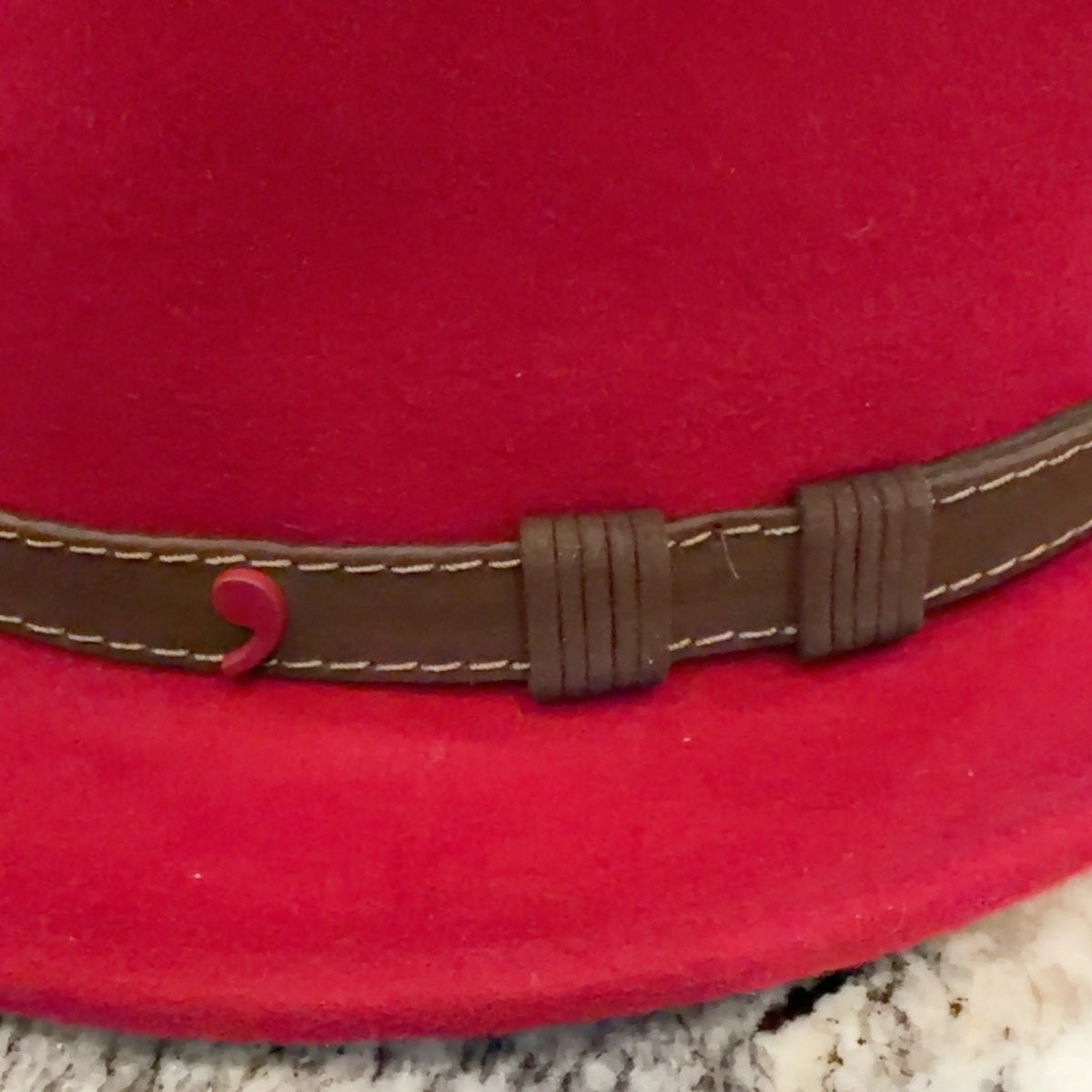 Brown leather band with contrast stitching and red Alfonso emblem on fedora 52821