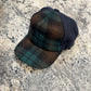 Green and brown plaid Alfonso d’Este Trucker cap with navy panels, front angle