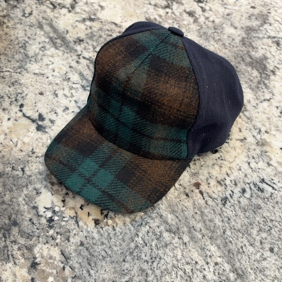 Green and brown plaid Alfonso d’Este Trucker cap with navy panels, front angle
