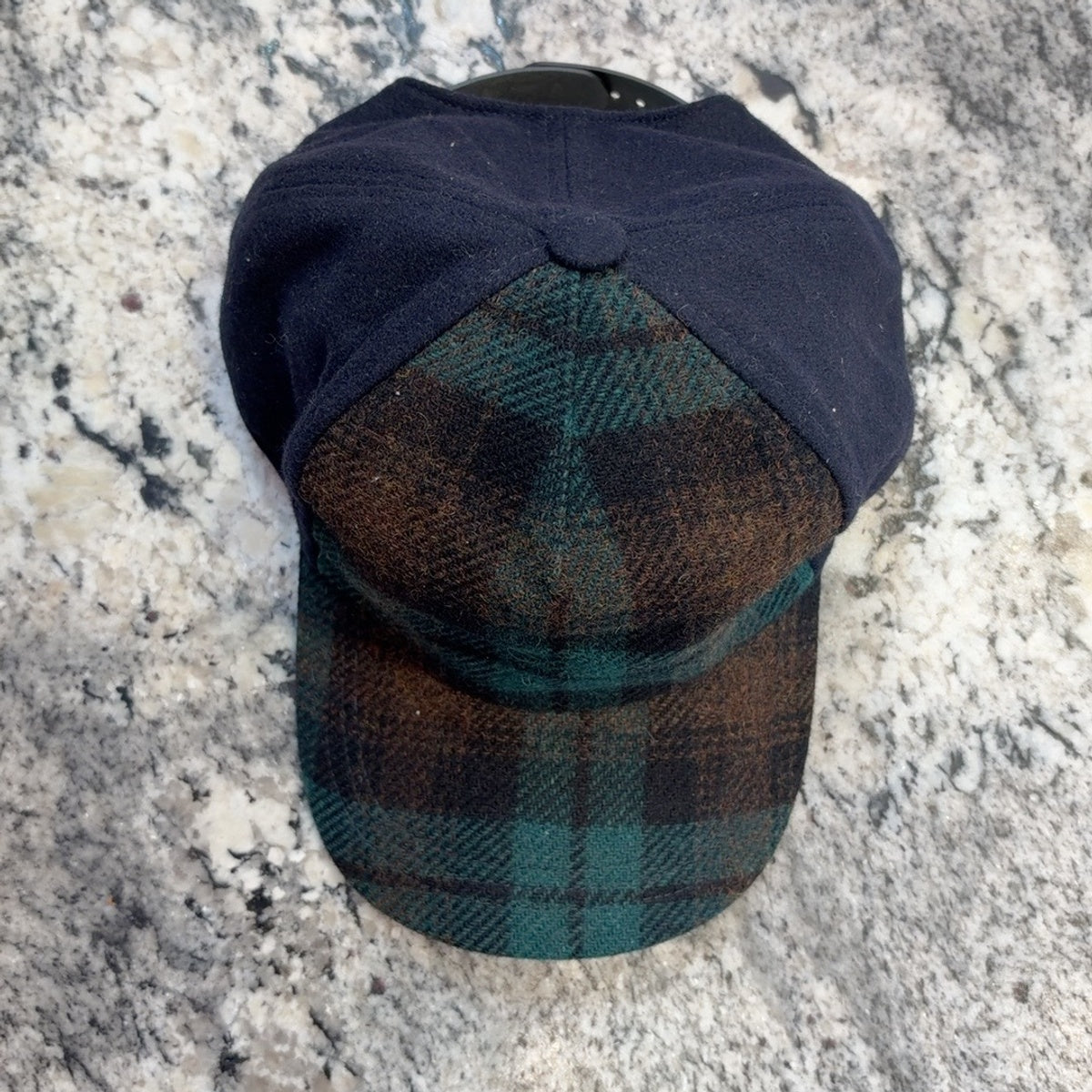 52888 Trucker cap front view showing plaid brim and navy crown panels