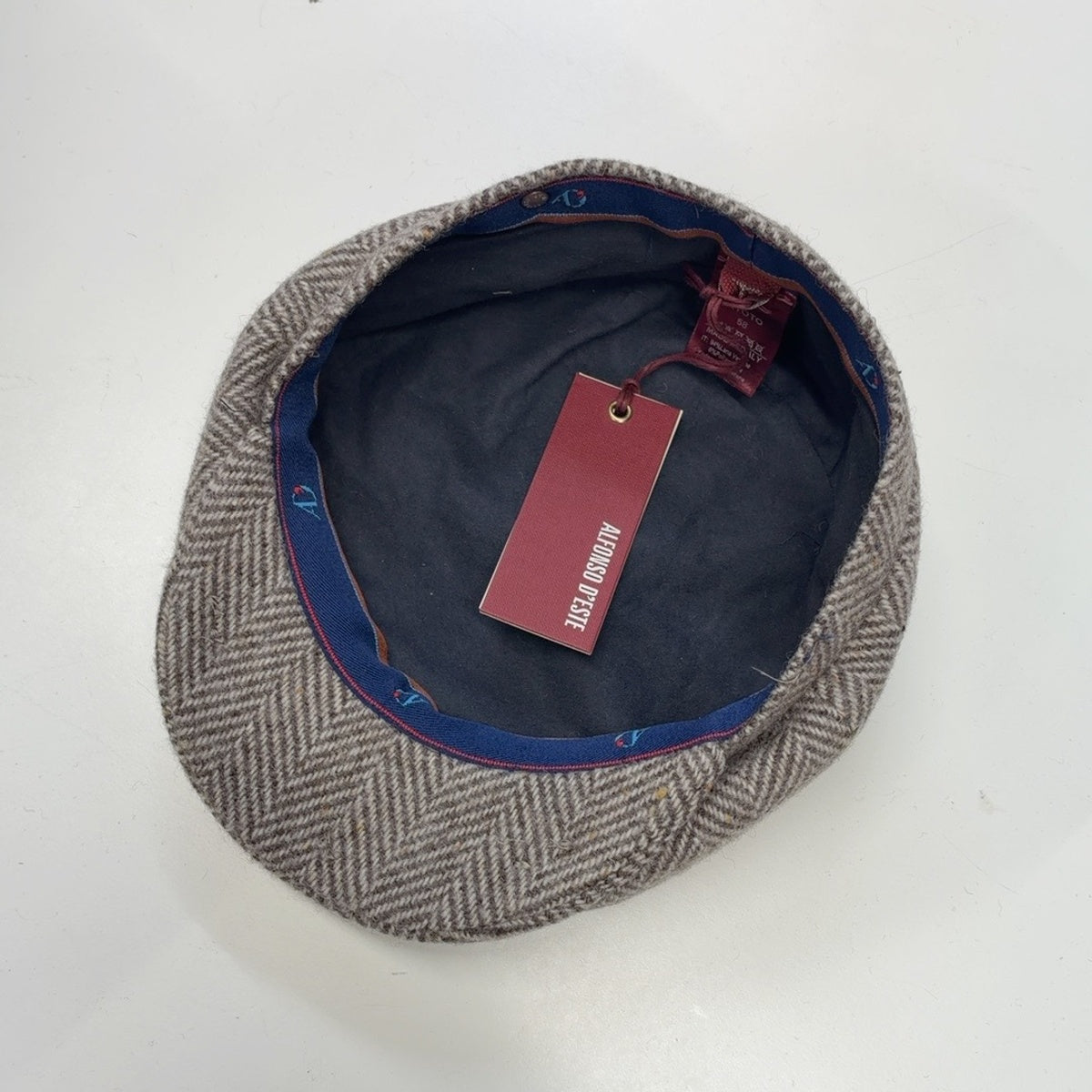 Interior of Alfonso D'Este Kyoto newsboy cap 54147 showing dark lining and blue branded sweatband
