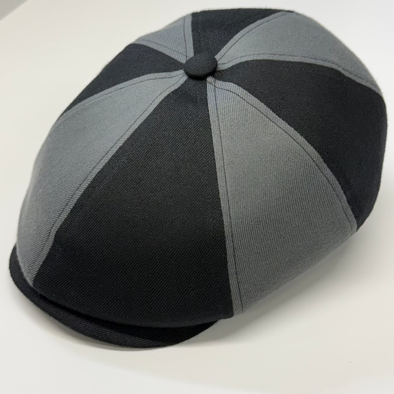 Black and gray checkered cap on a white background