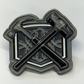 Metallic emblem with crossed axes on a white background