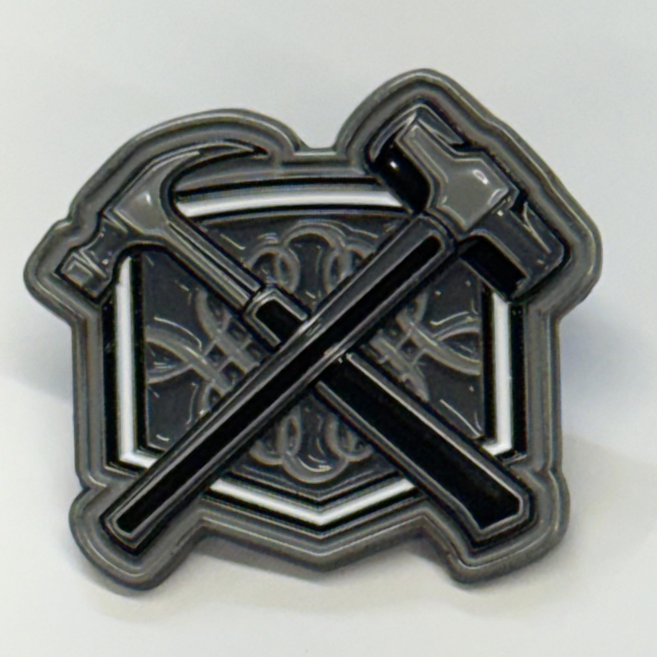 Metallic emblem with crossed axes on a white background