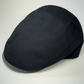 Black flat cap on a white background