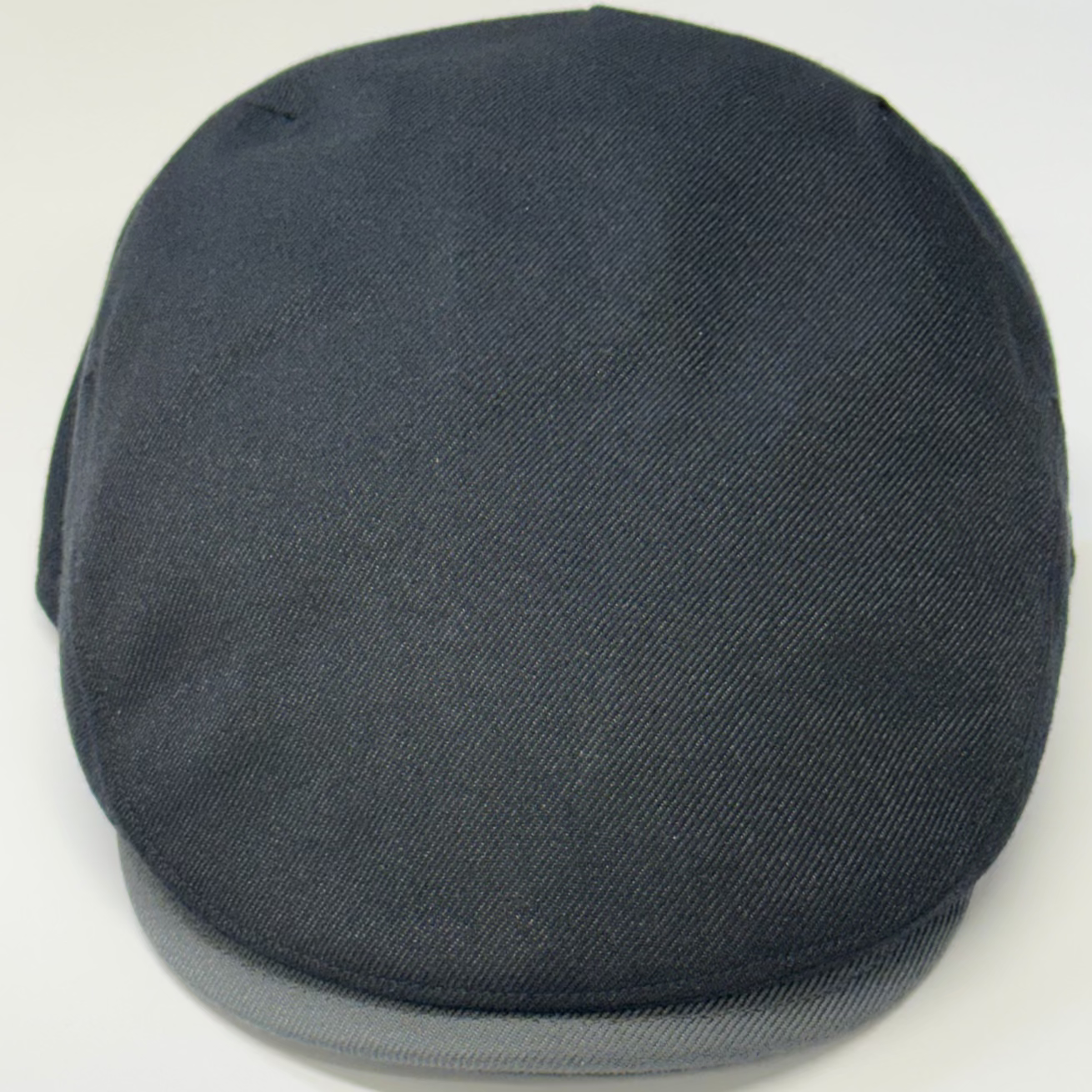Dark gray flat cap on a white background