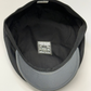 Black and gray cap with a visible brand label on a white background