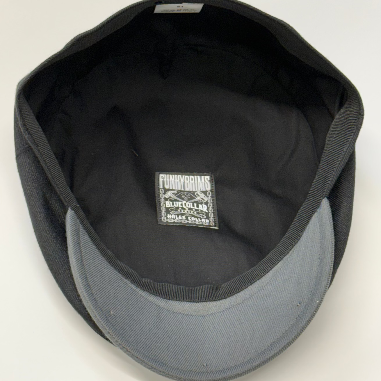 Black and gray cap with a visible brand label on a white background