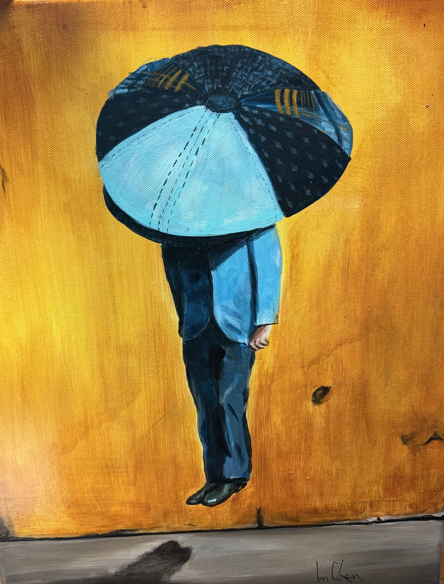 Person holding a large blue umbrella against a yellow background