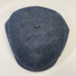 Blue checkered flat cap on a light beige background