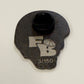 Black plastic component with 'FB' logo and number '3/150' on a beige background