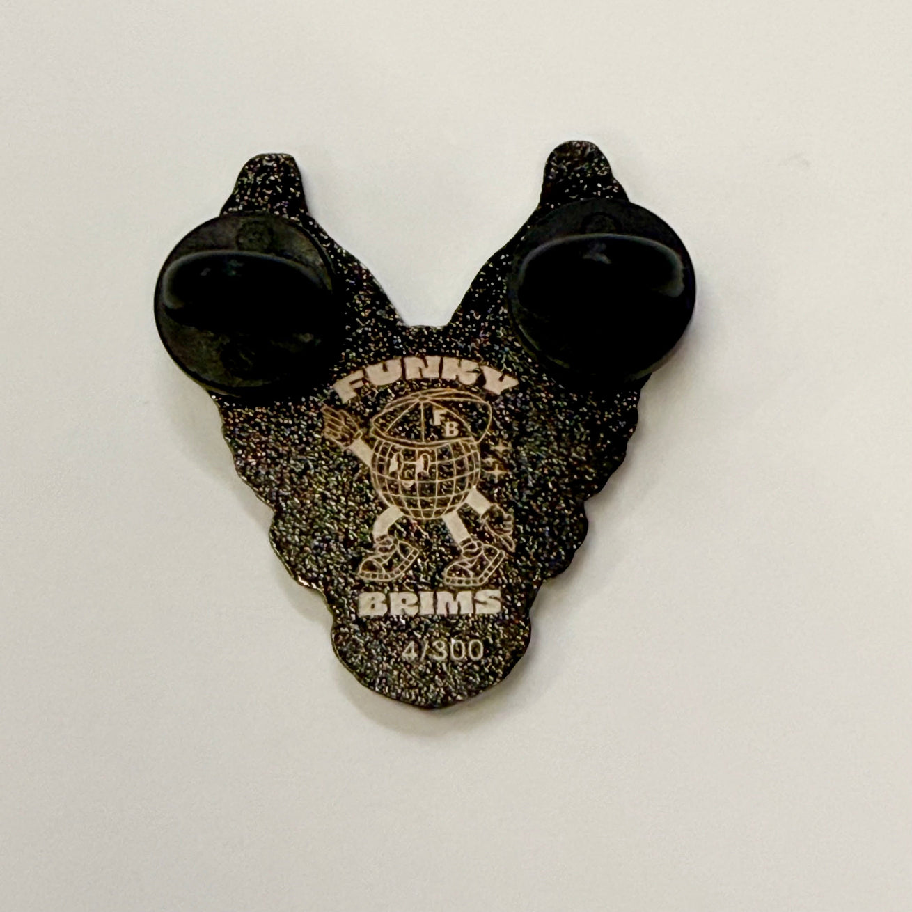 Black and gold object with 'Funky Grms' branding on a white background