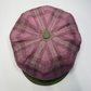 Purple checkered cap with a green button on a white background
