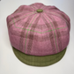 Pink and green checkered cap on a white background