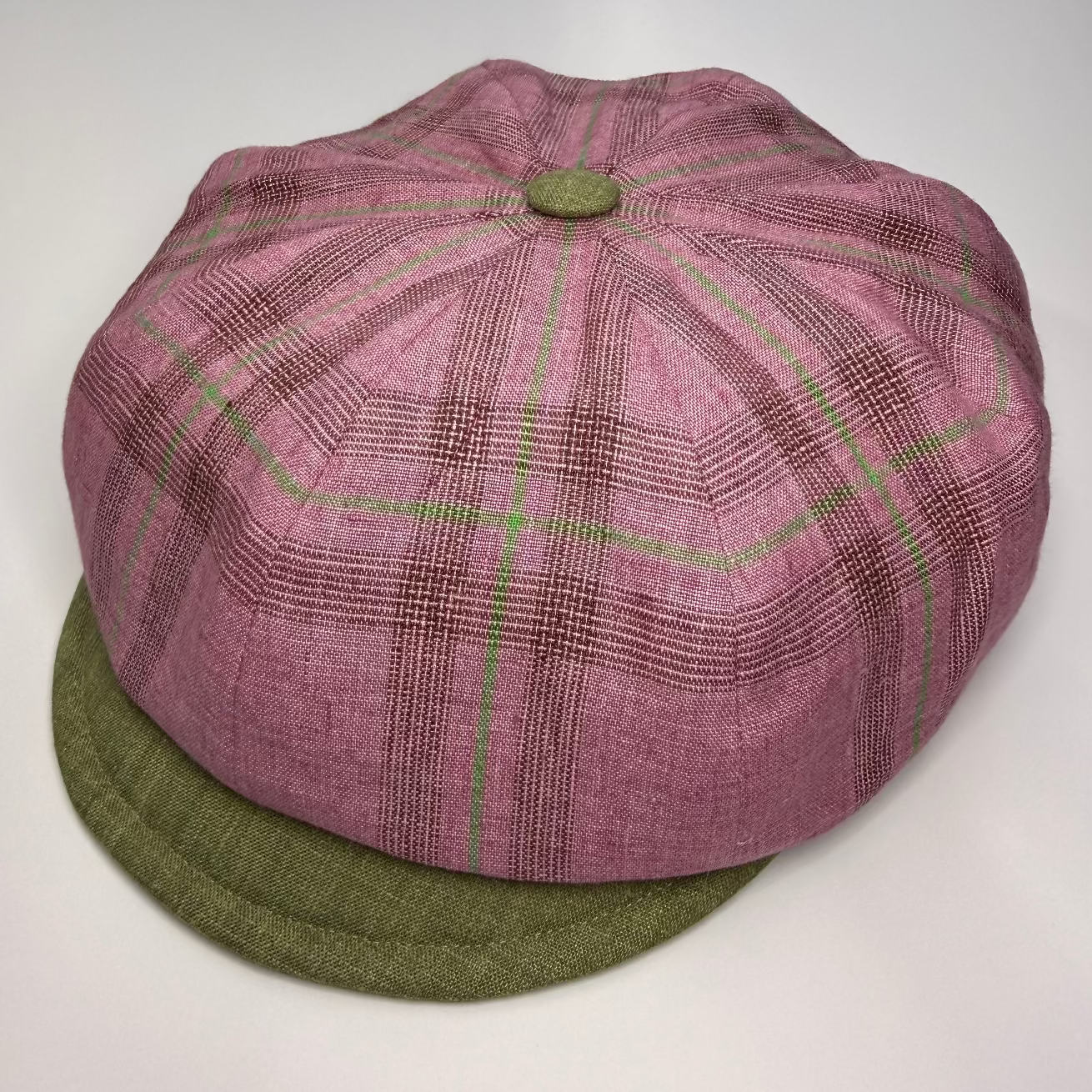 Purple checkered cap with green base on a white background