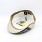 A vintage-style newsboy cap shown from the inside, featuring a beige and brown patterned fabric exterior and a white interior lining with attached tags.