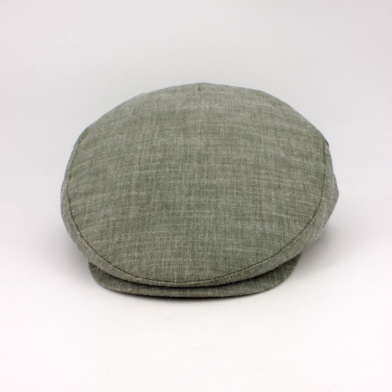 Green flat cap on a white background