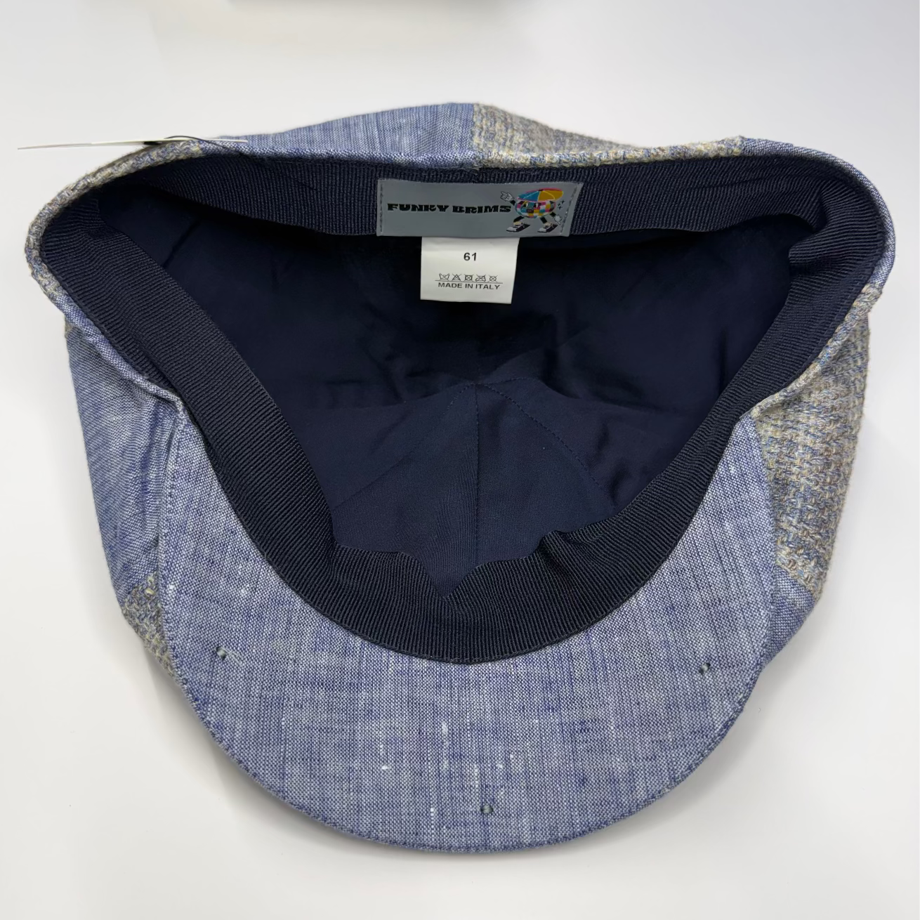 Blue denim cap with black interior on a white background