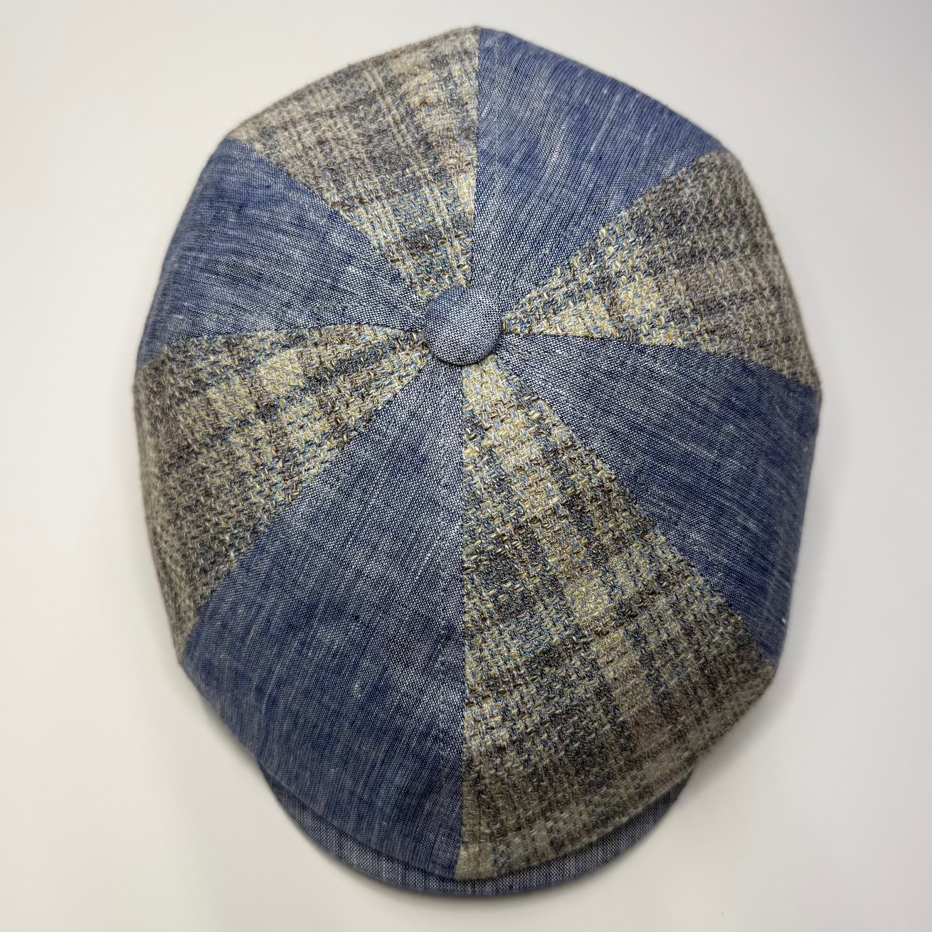 Blue and beige checkered beret on a white background