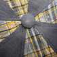 Close-up of a gray and yellow checkered fabric with a button detail