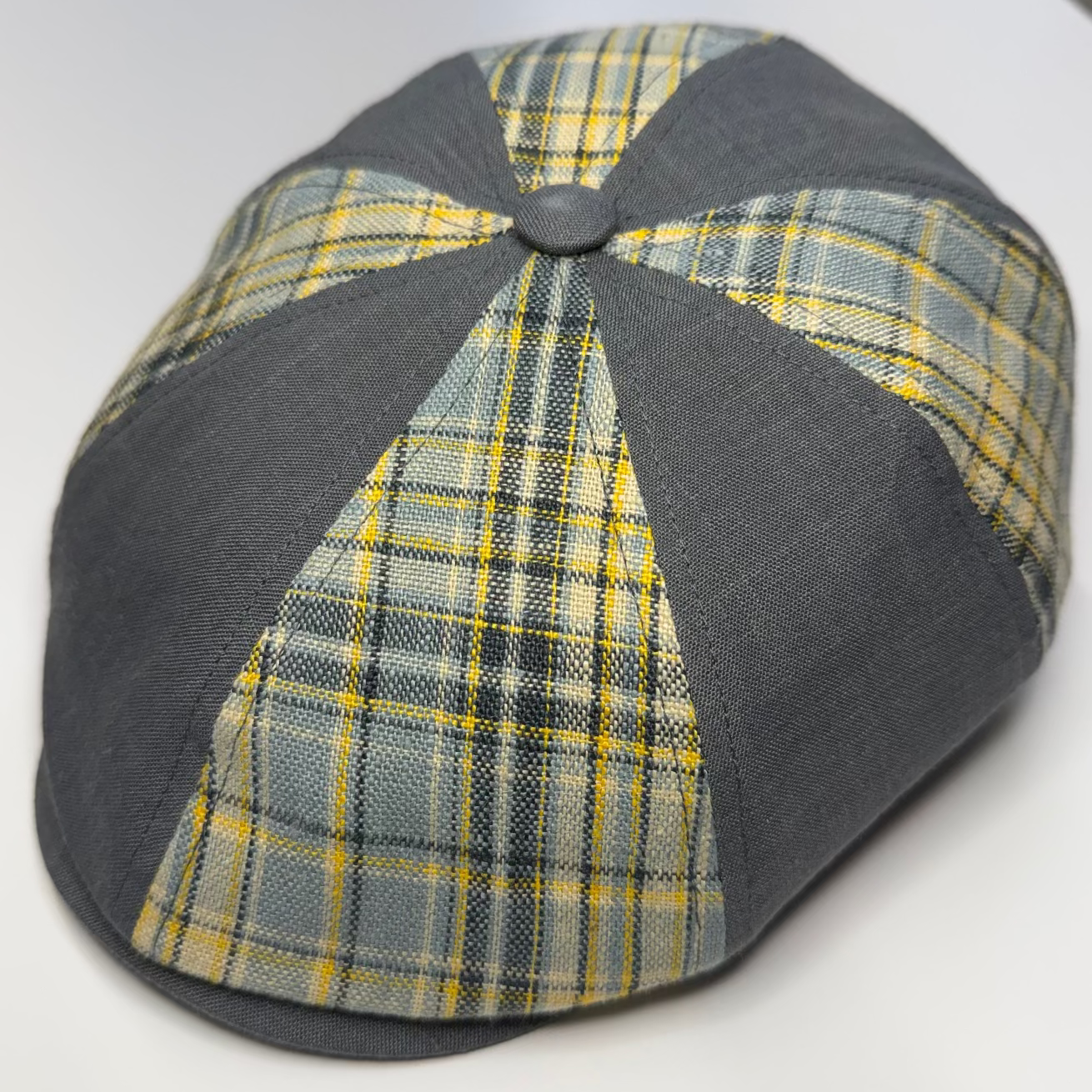 Plaid patterned cap with gray base on a white background