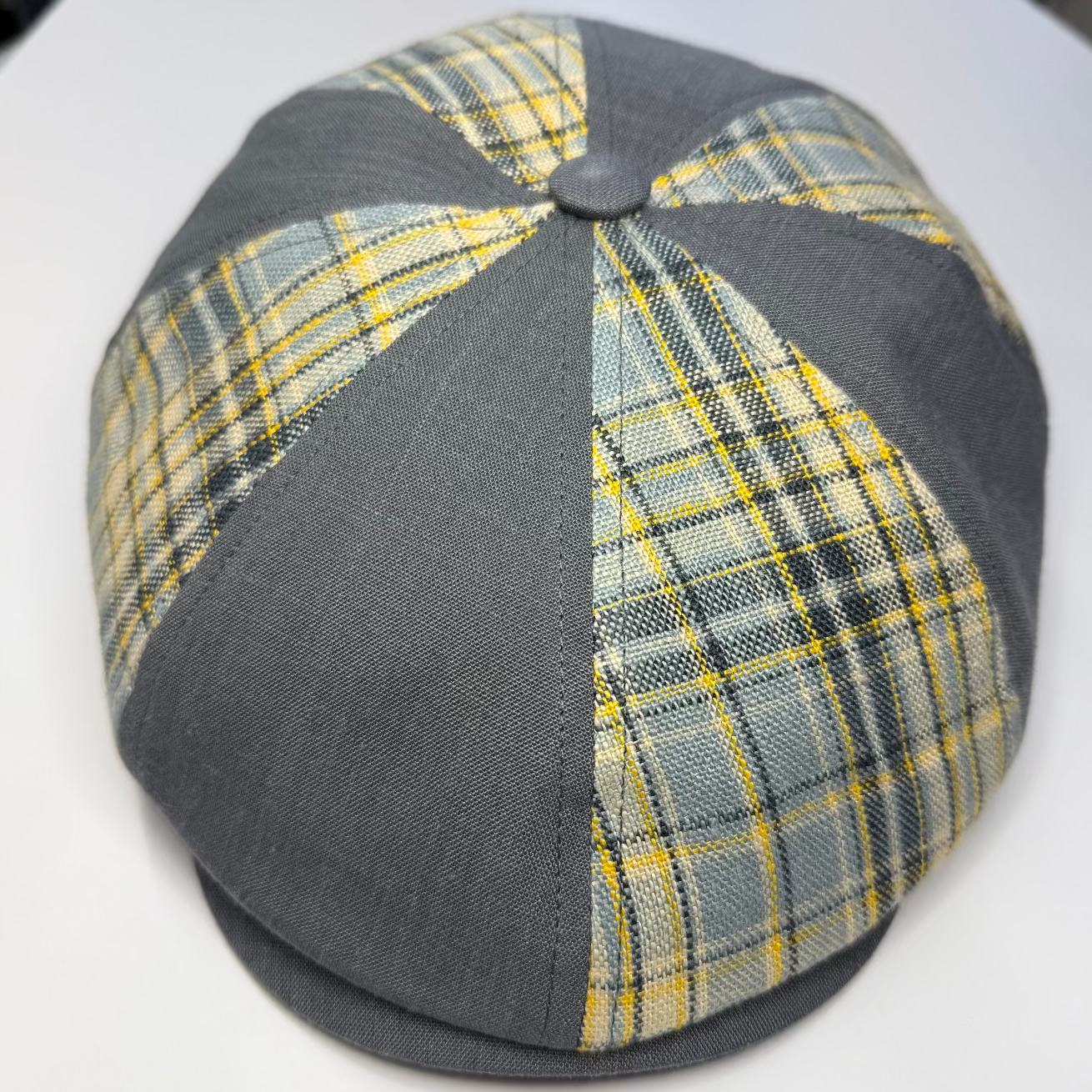Plaid patterned cap with gray base on a white background